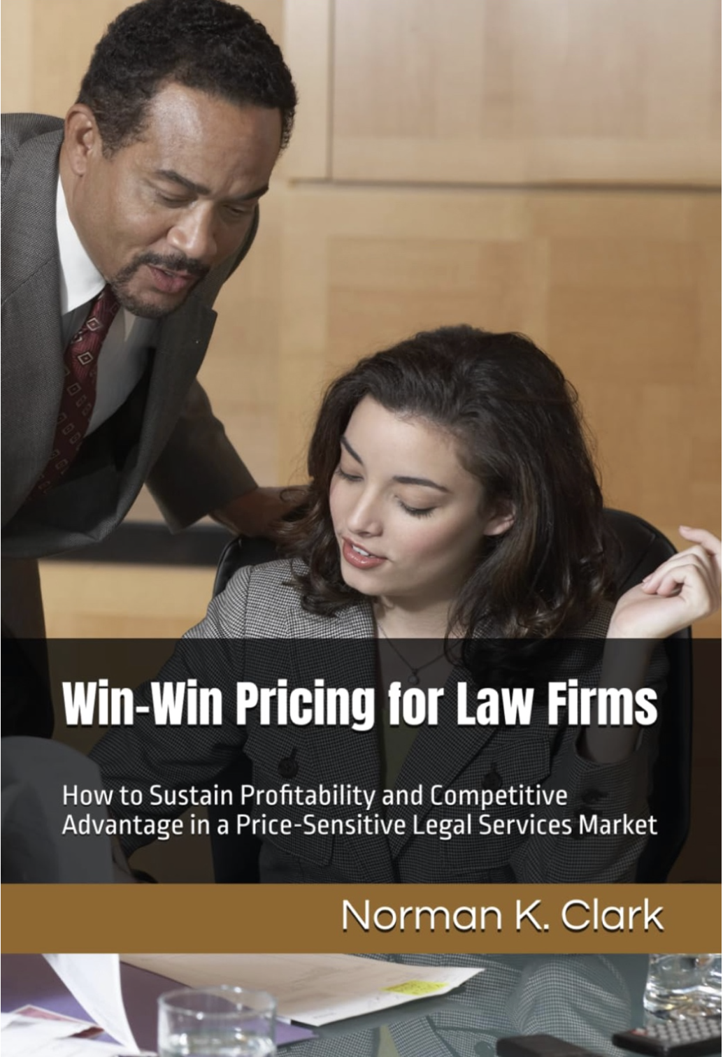 The cover of a book called "Win-Win Pricing For Law Firms" featuring a seated female and a standing male who are working together, reviewing a document on a desk.