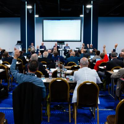 Members of a committee voting by raising their hands.